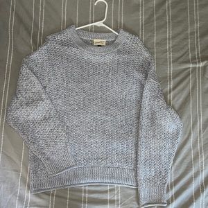 Grey knitted women’s sweater.